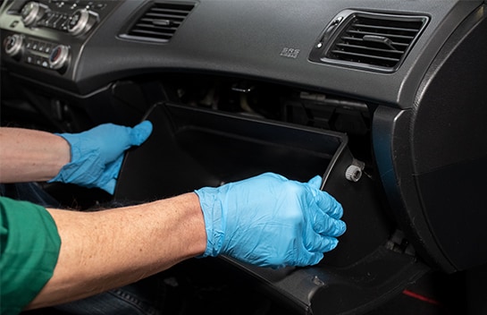 Man with gloves holding an empty glove box