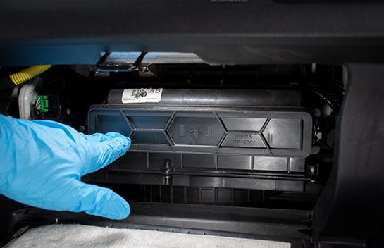 Hand pointing at the housing tray after installation