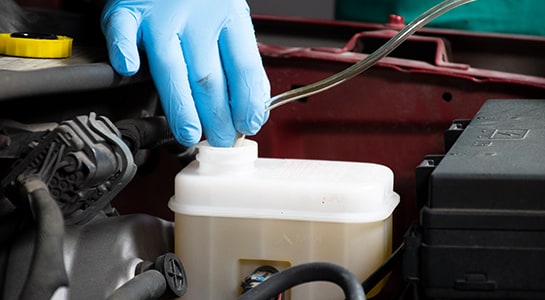 Siphoning old brake fluid from master cylinder reservoir on 2008 Dodge Nitro
