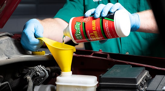 Pouring O'reilly brake fluid into the master cylinder