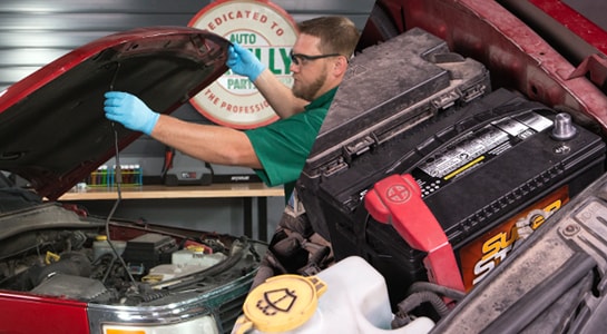 Propping up the hood of truck and disconnecting car battery terminal