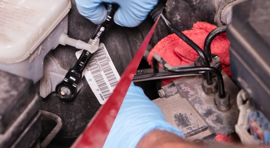 unscrewing master cylinder mounting nuts