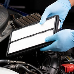 Hands holding an air filter