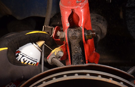 Close-up shot of Blaster rust penetrant being used on the Civic’s nuts and bolts, being prepared for removal.
