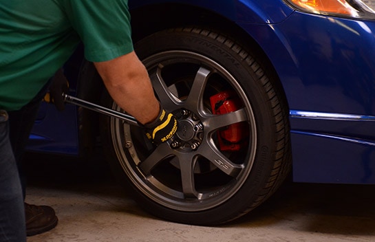 Image of lug nuts being tightened with a torque wrench