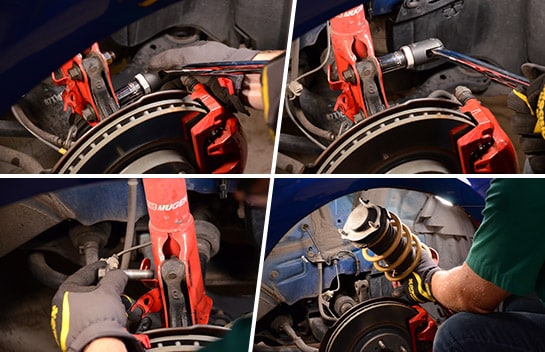 Civic’s strut assembly lug nuts being removed with a torque wrench and the old strut assembly being lifted from the wheel well