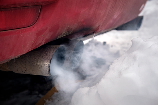 Exhaust gas pouring out of a vehicle's tailpipe.