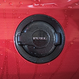 gas tank door on vehicle with water dripped down the car