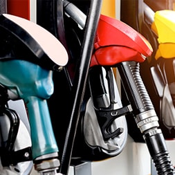 different colored gas pumps lined up