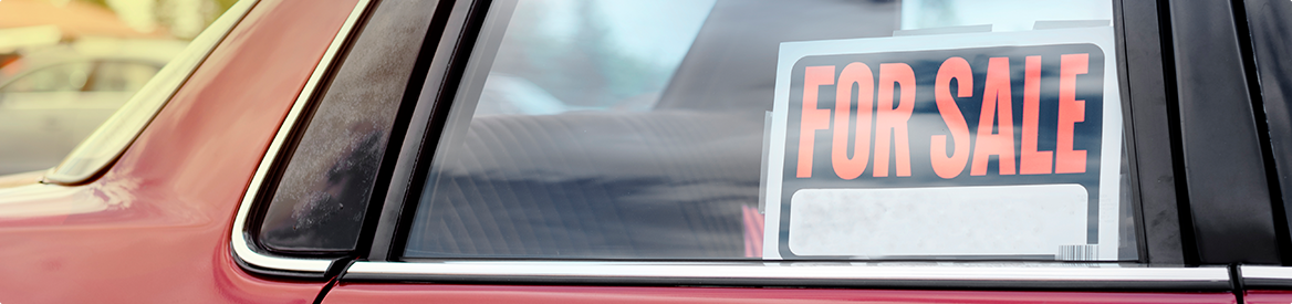 For Sale sign in red vehicle