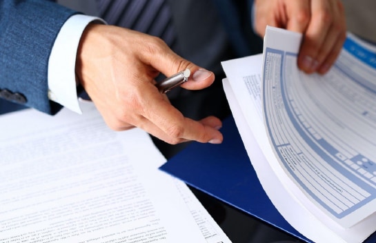 hands working through paperwork