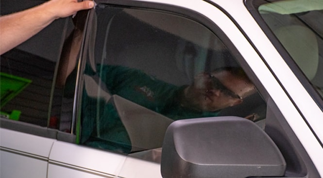 Finding a corner to start removing the liner from the film. 