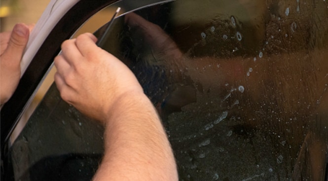 Removing water or bubbles under the film with the squeegee