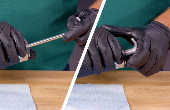 Our expert pushes the grease gun’s inner rod to push out any extra air in the gun.