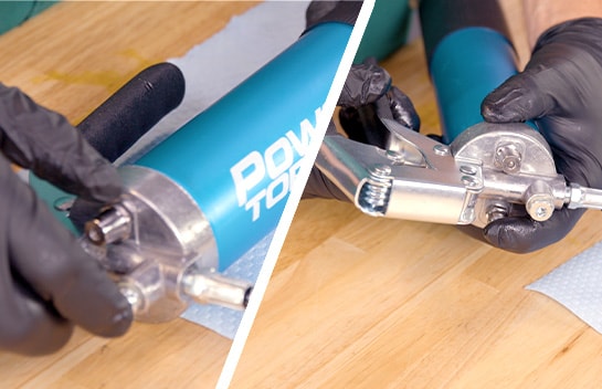 The air bleeder is depressed to force out remaining air in the grease gun.