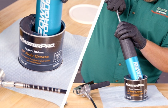 The grease gun end is submerged in the grease container and the inner rod is pulled up.