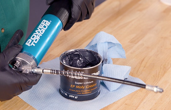 The grease gun’s head is reattached to the barrel.