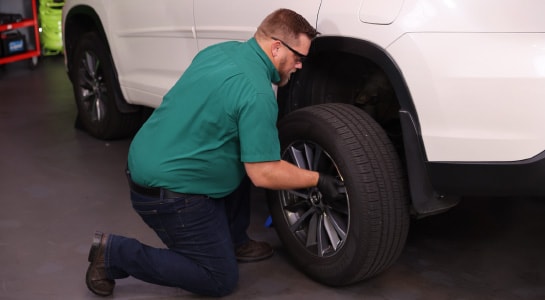 The driver’s side rear wheel is fully removed from the vehicle.