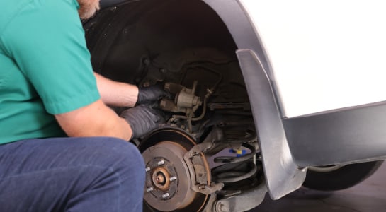 Our expert removes the caliper from the rotor.