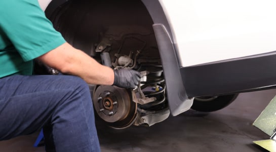 The caliper bracket is removed and set aside.