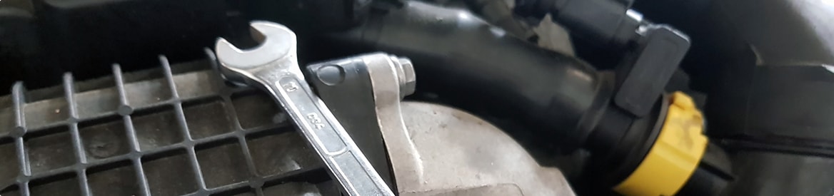 Spanner and timing belt on car engine