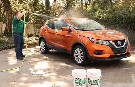 Car getting sprayed with hose