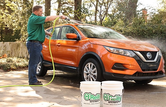 Rinsing vehicle with water from hose