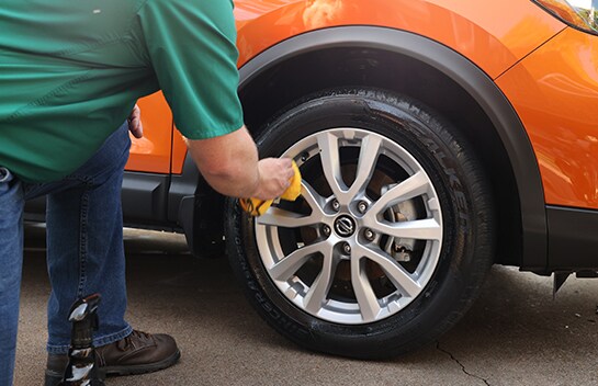 Wiping tire off with cloth