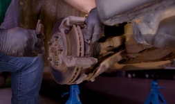 Mechanic working on a vehicle's brakes