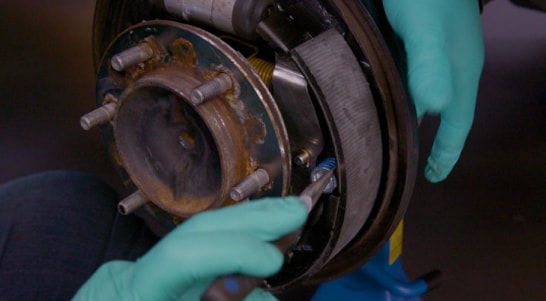 Install the rear brake shoe, using needle-nose pliers to secure hardware.