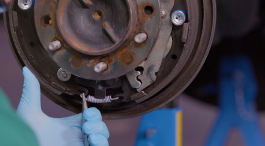 Use needle-nose pliers to install the tension spring.