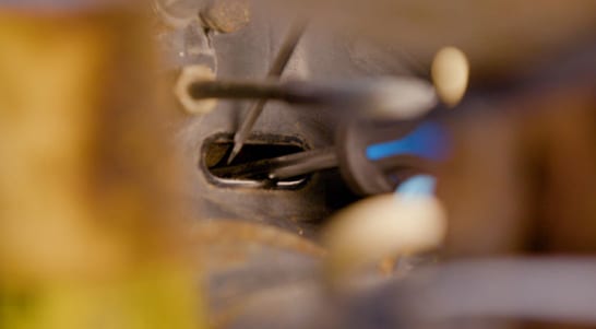 Use screwdrivers to adjust the brake shoes inward so the drum can be removed.