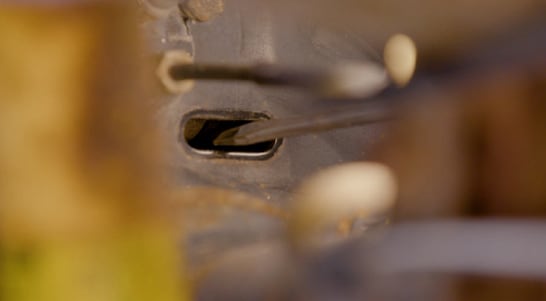 Use a flat blade screwdriver to adjust the brake shoes.