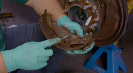 Use a screwdriver to remove the two C-clips.