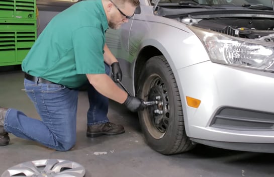 Remove your wheel cover and loosen the lug nuts on the front passenger-side wheel.