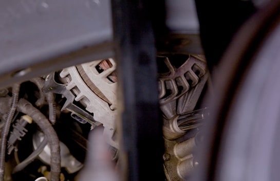 Torque the alternator mounting bolts to 26 foot-pounds.