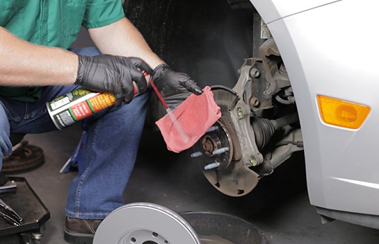 Use brake cleaner on a shop towel or rag to clean the friction surface of your new rotor.