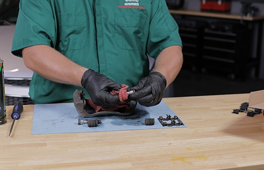 Wipe the slide pins clean and apply fresh silicone grease. 