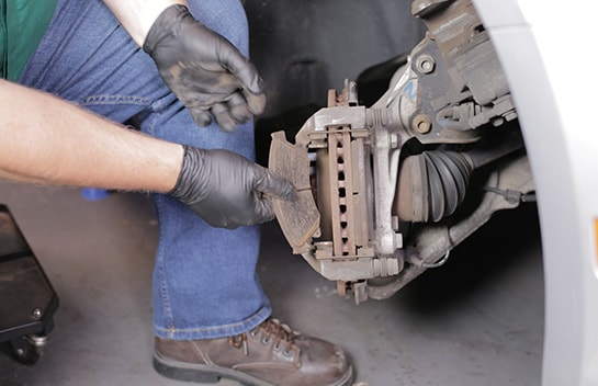Remove the old brake pads from the caliper bracket. 