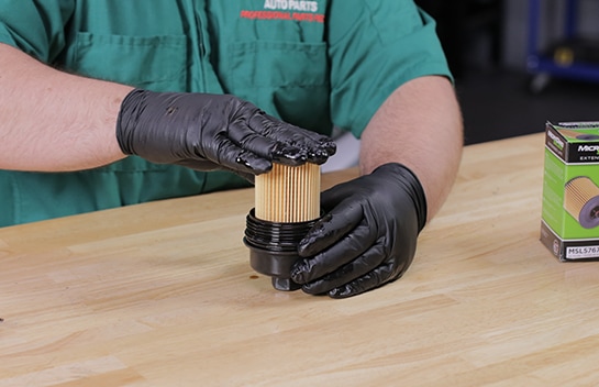 Install the new filter in the cap.