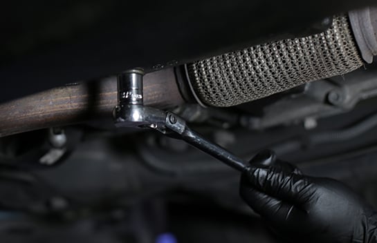 Loosen the drain plug with a 16mm socket and ratchet.