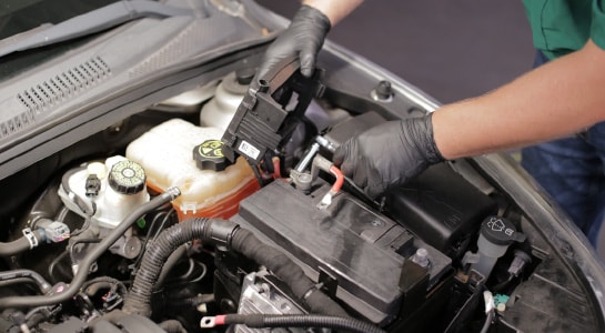 Use a 10mm deep socket to detach the positive battery cable.