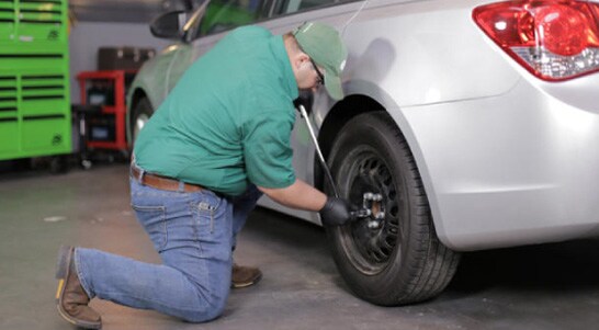 Loosen the lug nuts on the rear wheels with a 19mm socket and breaker bar.