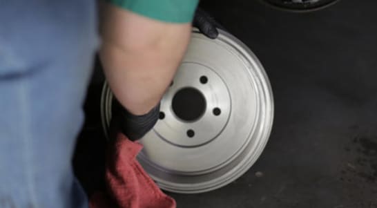 Clean your brake drum with brake cleaner and a shop towel or rag.