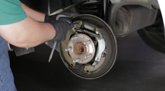 Use a hook, pliers or screwdriver to detach the adjuster spring.