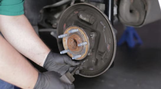 Remove the parking brake cable from the parking brake lever to disengage and remove the rear brake shoe. 