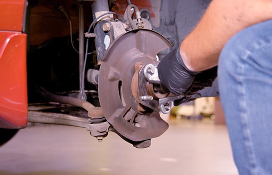 Use the lug nuts you removed to attach the hub puller to the studs.