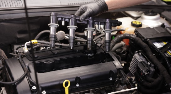 Remove spark plug wires or ignition coils.