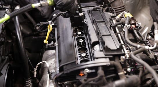 Use an air hose to blow out any dirt before removing the spark plugs.