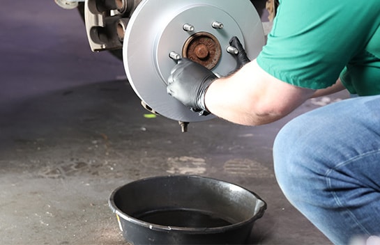 Auto parts professional installing a new rotor on a Ford F-150